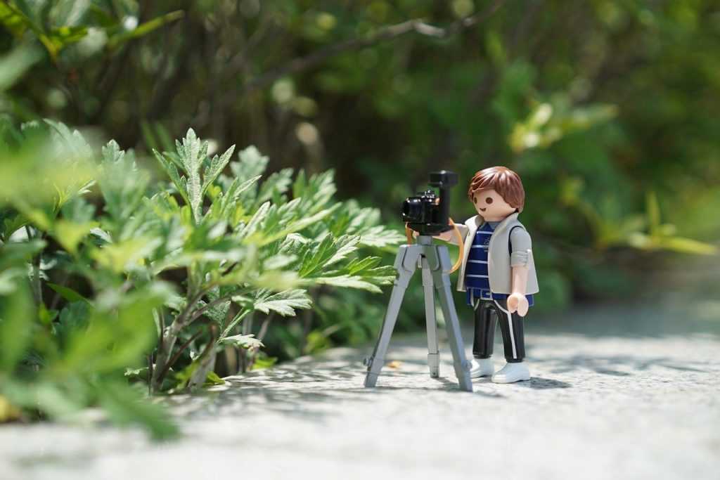 A mini size cameraman with a mini camera for pre-wedding shooting