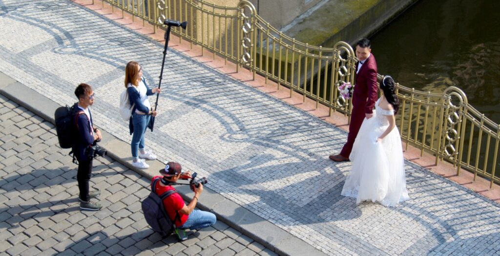 A wedding couple having photoshoot on the street